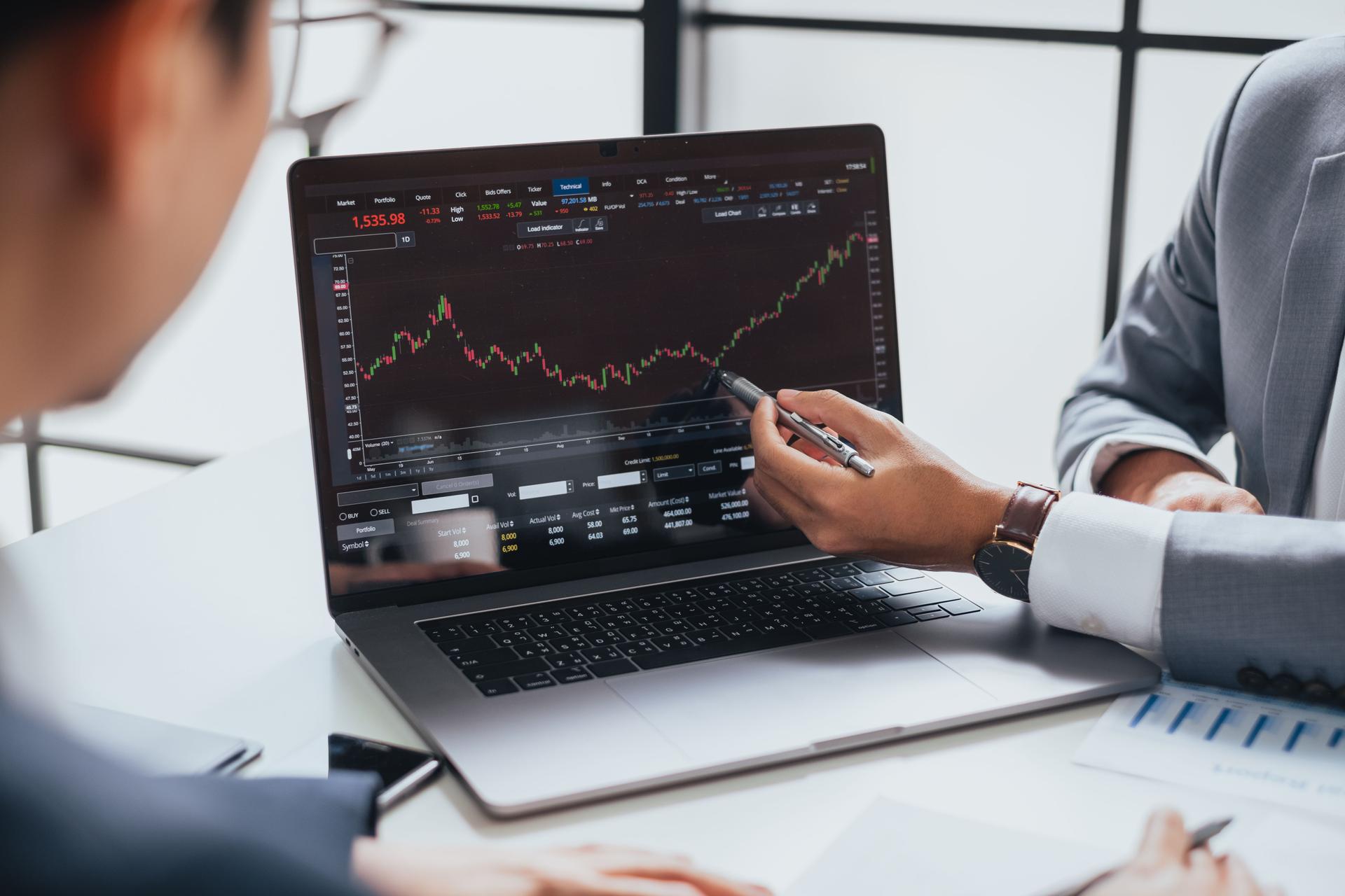 Businessman talking about investment stock market and graph from computer laptop with broker trader, giving money plan management and analysi